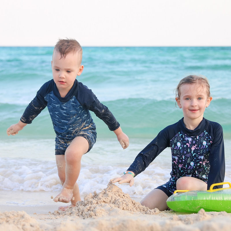 Premium Photo Little Toddler Boy Wearing Sun Protection Swimsuit Playing  With Water At The Sea Side During Summer Vacation In Child Enjoying Family  Holidays